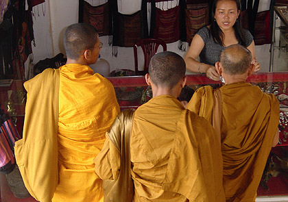 a group of Buddhist monks at a shop in Vientiane